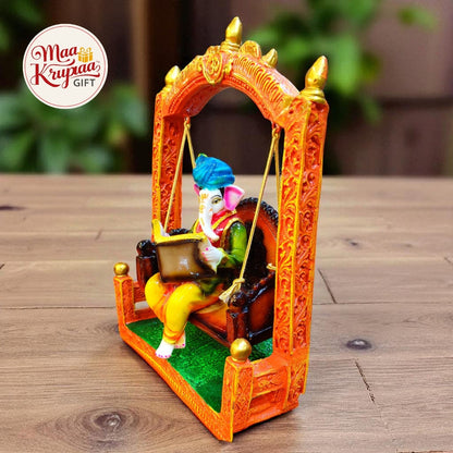 GANESHA ON SWING WITH BOOK – DECORATIVE IDOL W102